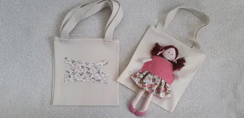 Bolsa canguru e Boneca Amiguinha