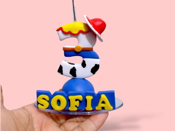 Vela tema brinquedos cowboy menina em biscuit