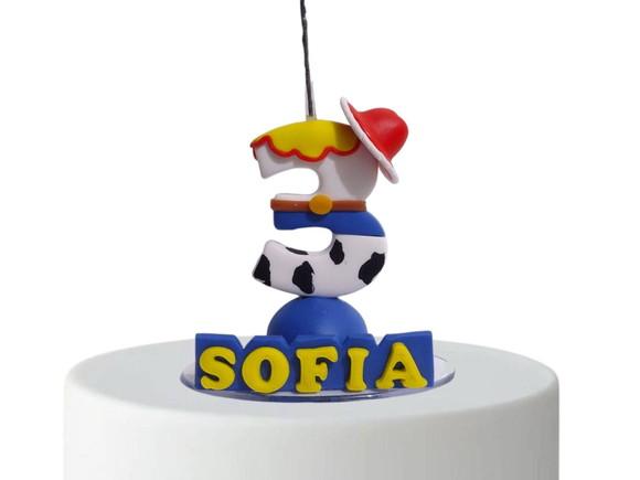 Vela tema brinquedos cowboy menina em biscuit