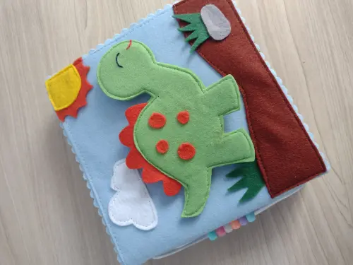 Livro sensorial do dinossauro em feltro para crianças
