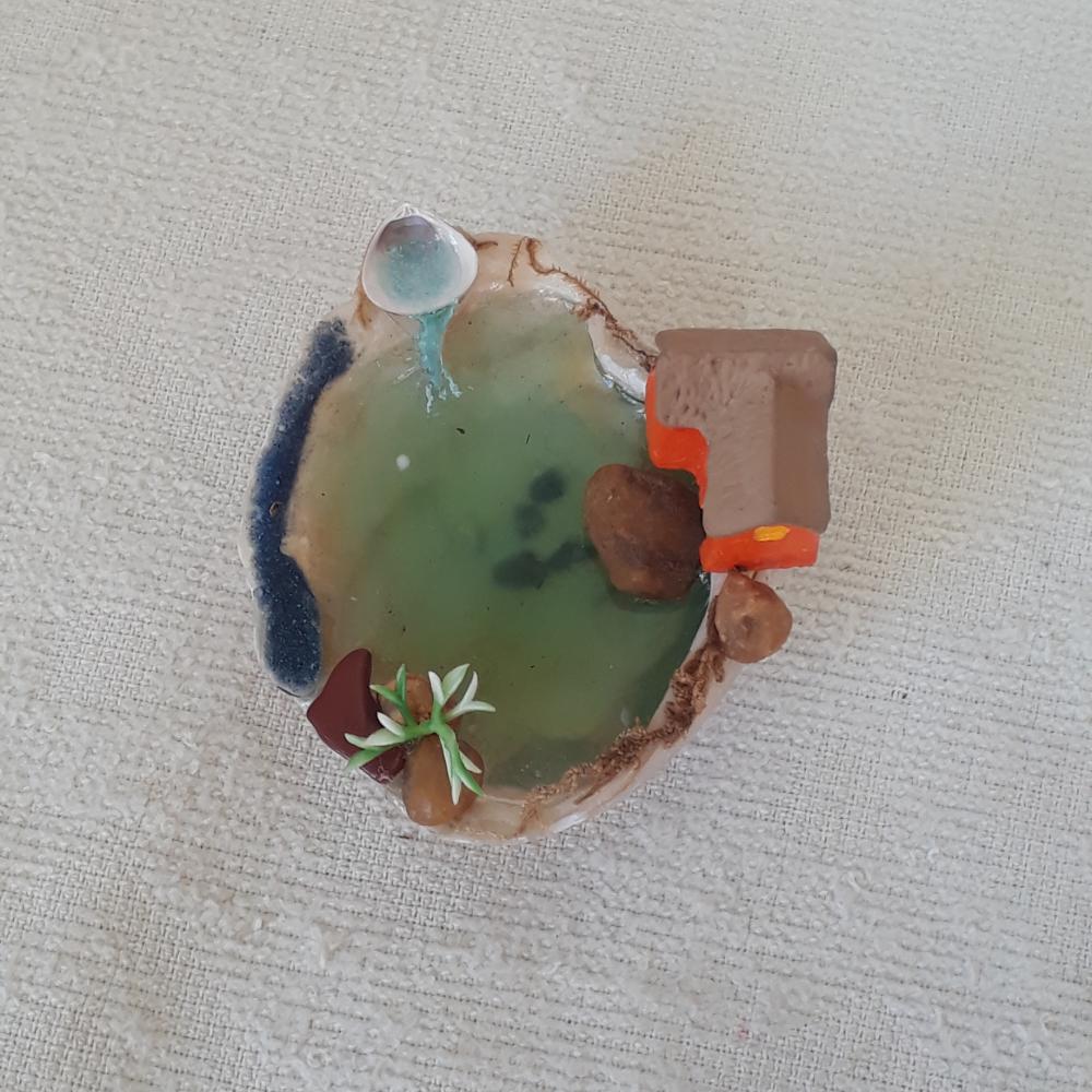 Cenário com concha e miniatura de caa de resina